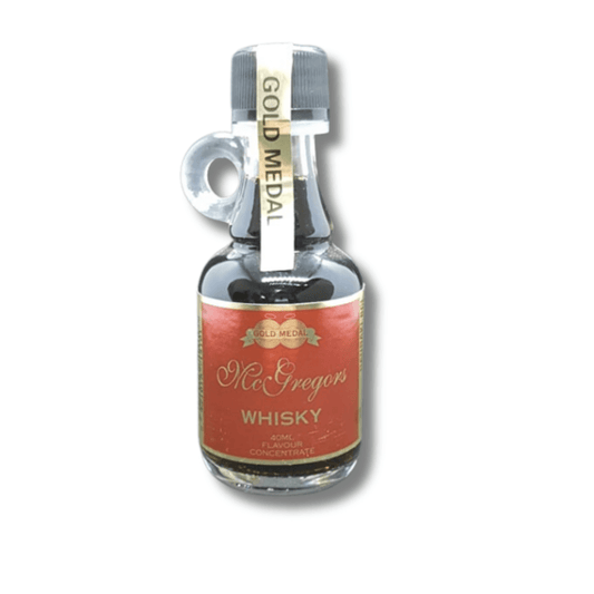 tiny glass bottle with cute handle filled with dark coloured whiskey spirit essence