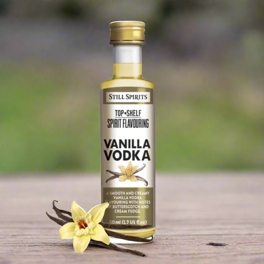 bottle of vanilla vodka essence with beautiful vanilla orchid and dried bean pod next to it