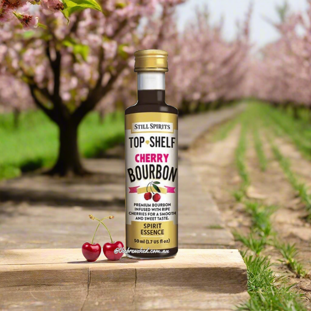 clear coloured bottle with dark liquid inside, cherries on lable