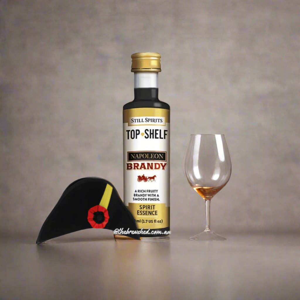 clear bottle filled with dark liquid and a french bircorne hat next to it