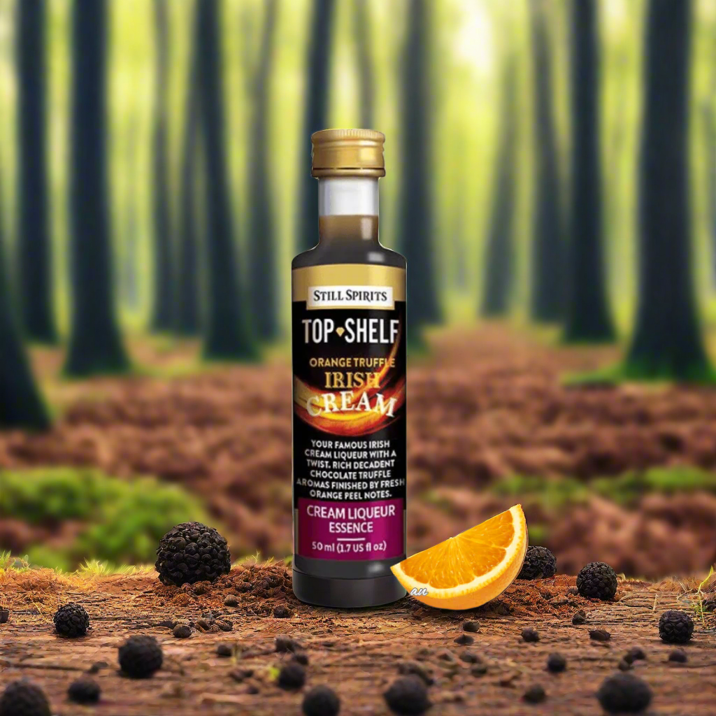 orange slice with bottle of dark liquid inside, black and orange label