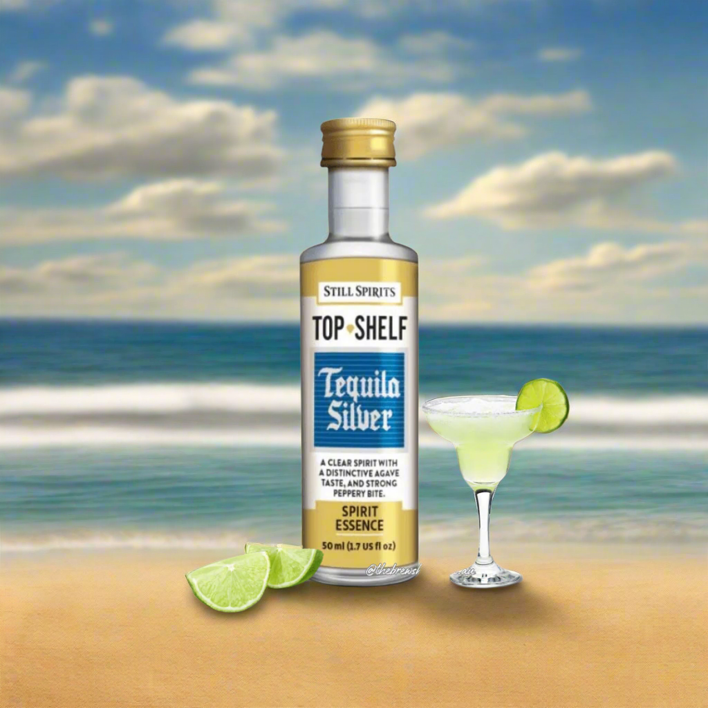 juicy limes and a margherita cocktail next to a white, blue and gold labelled bottle