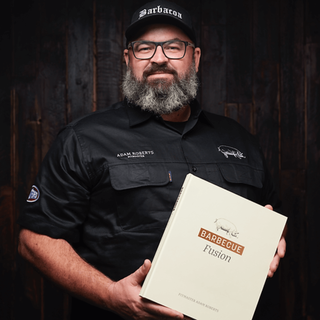 pittmaster adam roberts holding his book BBQ fusion