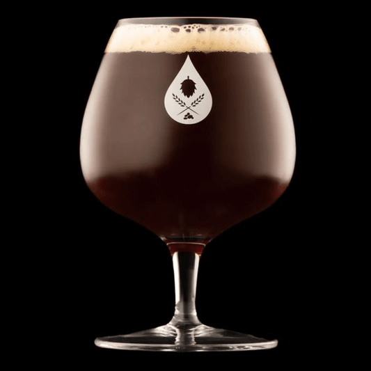 a round and volumous beer glass with a stout beer 