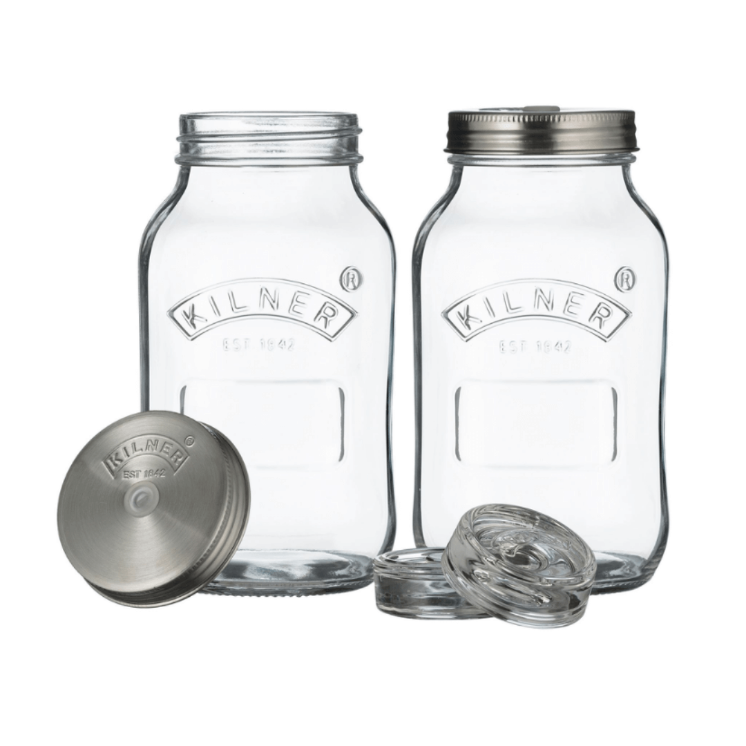 two clear glass jars with metal lids and airlock