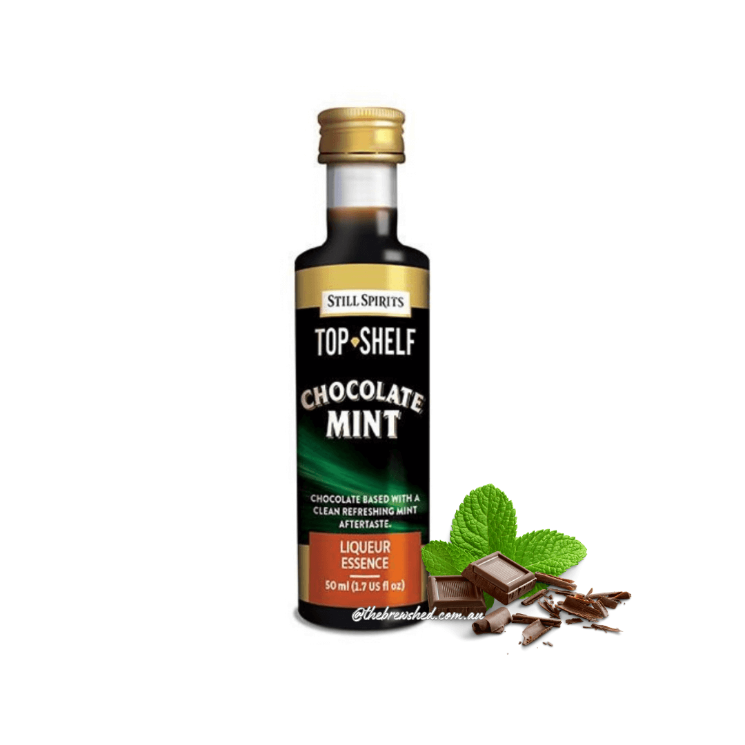 bottle with dark liquid inside, chocolate and mint leaves next to bottle