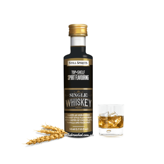 fancy black and gold label with barley sheaf offset from clear bottle with dark liquid inside